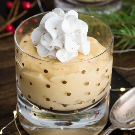 Eggnog Pudding in glass topped with whipped cream square image