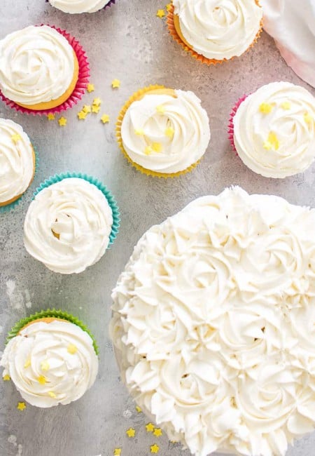 Square image of the Best Fluffy Buttercream Frosting on cupcakes and a cake