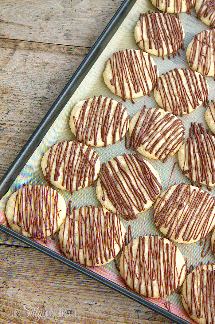 Potato Chip Cookies on baking sheet drizzled in chocolate.