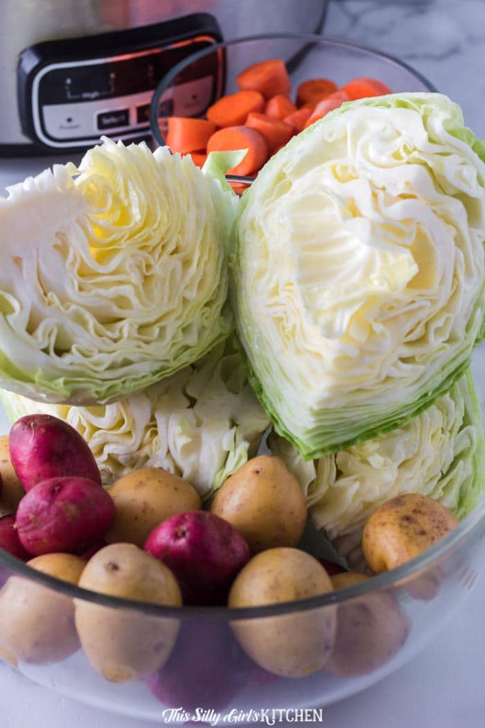 Vegetables in bowls in front of slow cooker
