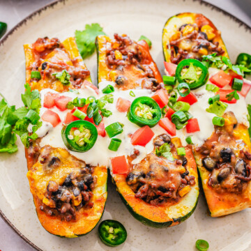 3 of the Enchilada Stuffed Zucchini pieces on plate.