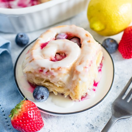 Square image of Sweet Roll on plate with fruit