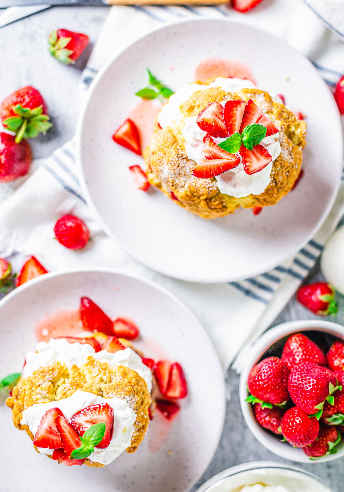 Overhead of Strawberry Shortcake Recipe with 2 on white plates topped with garnishes