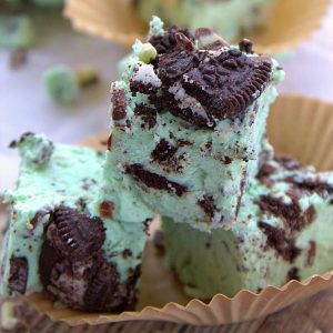 Square image of Mint Fudge on paper liner stacked close up.