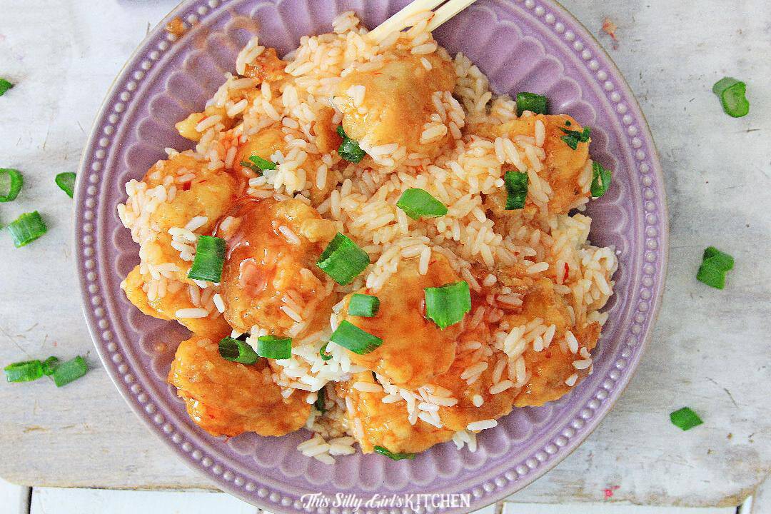 Instant Pot Sweet and Sour Chicken - Chicken cooked to perfection, smothered in gooey sweet n sour sauce, and served over steamed rice. recipe from https://thissillygirlskitchen.com #sweetandsourchicken #instantpot #instantpotsweetandsourchicken Finished Instant Pot Sweet and Sour Chicken on plate.