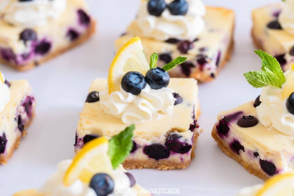 close up cheesecake bar with lemon blueberry garnish