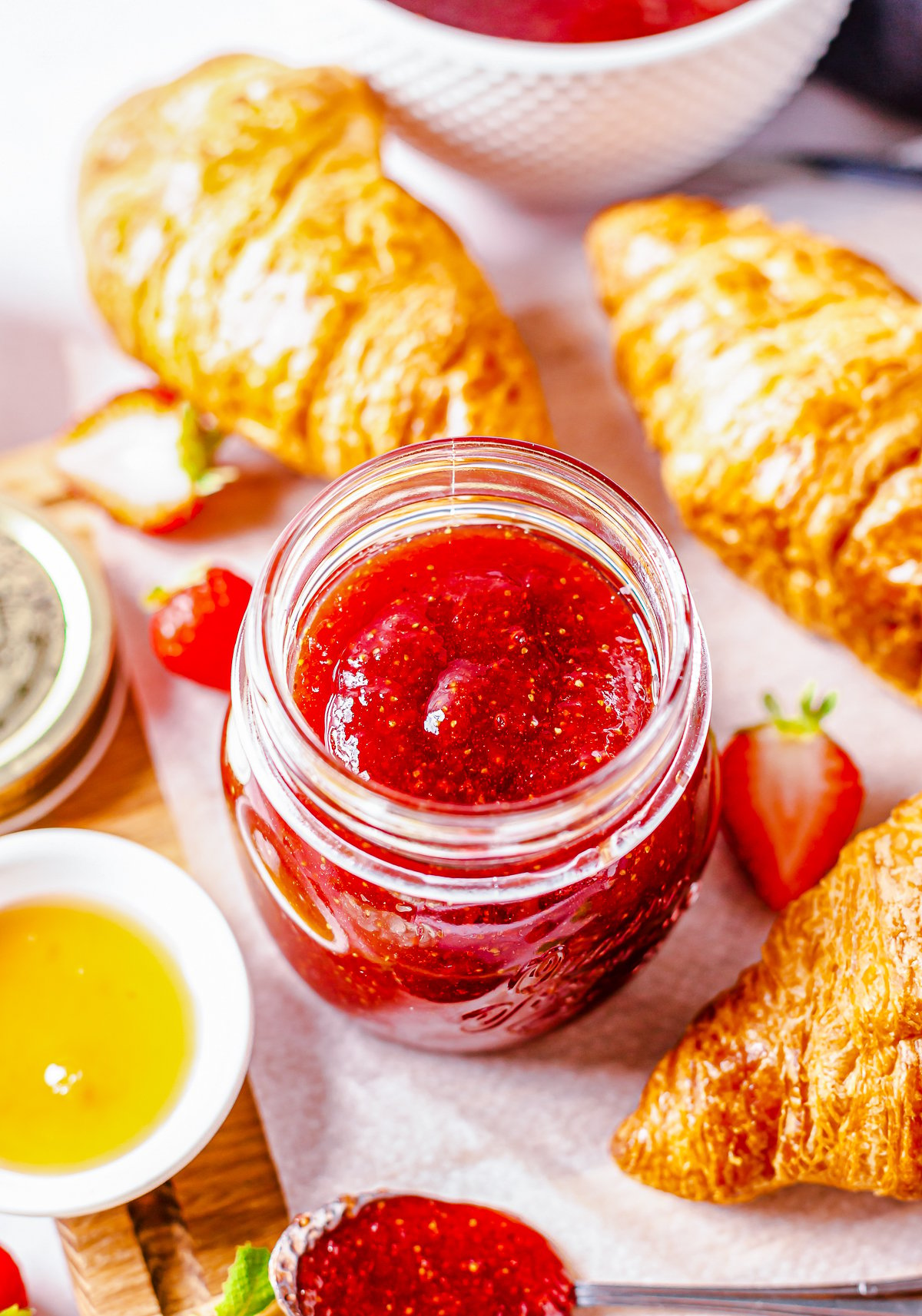 Overhead of Strawberry Butter surrounded by croissants.