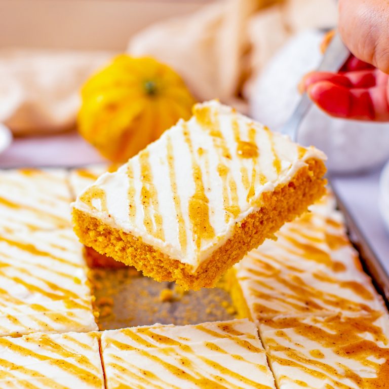 Square image of server holding up a slice of cake.