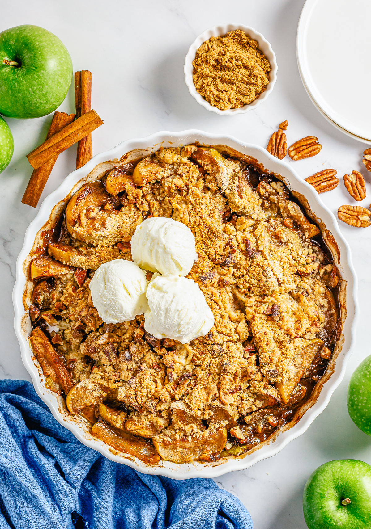 Easy Apple Crumble out of oven in baking dish topped with ice cream.