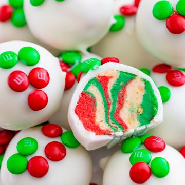 Stacked Oreo Truffles with one split open showing holiday colors