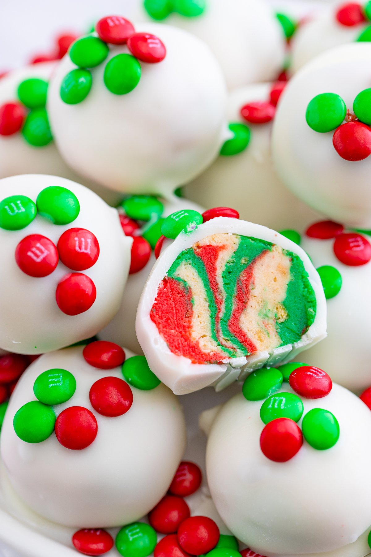 Stacked Oreo Truffles with one split open showing holiday colors