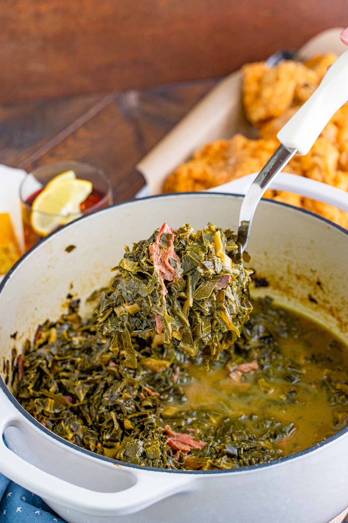 Ladle holding up some of the Southern Collard Greens from pan.