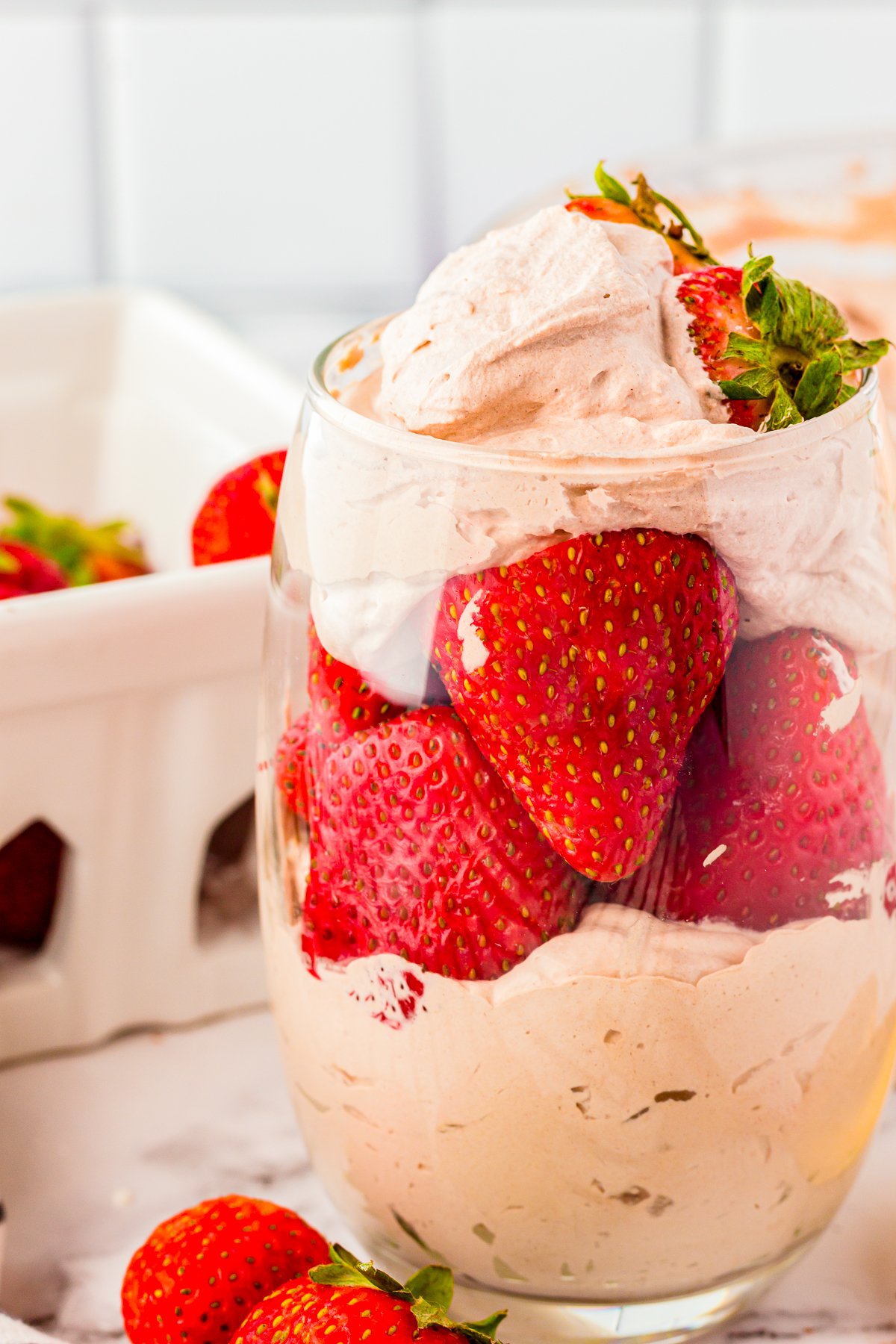 Close up of Chocolate Whipped Cream Recipe in glass with strawberries.