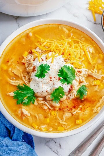 Square photo of chili overhead garnished in bowl.