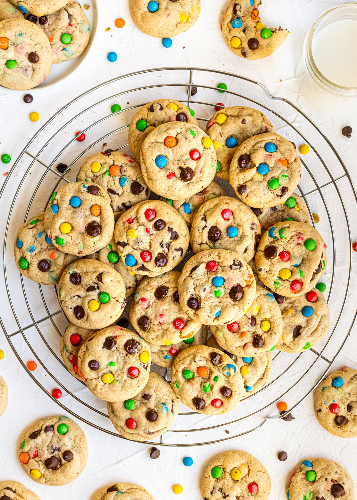 M&M Chocolate Chip Peanut Butter Cookies stacked on wire rack with cookies surrounding it