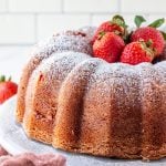 Finished Bundt Cake topped with powdered sugar and strawberries