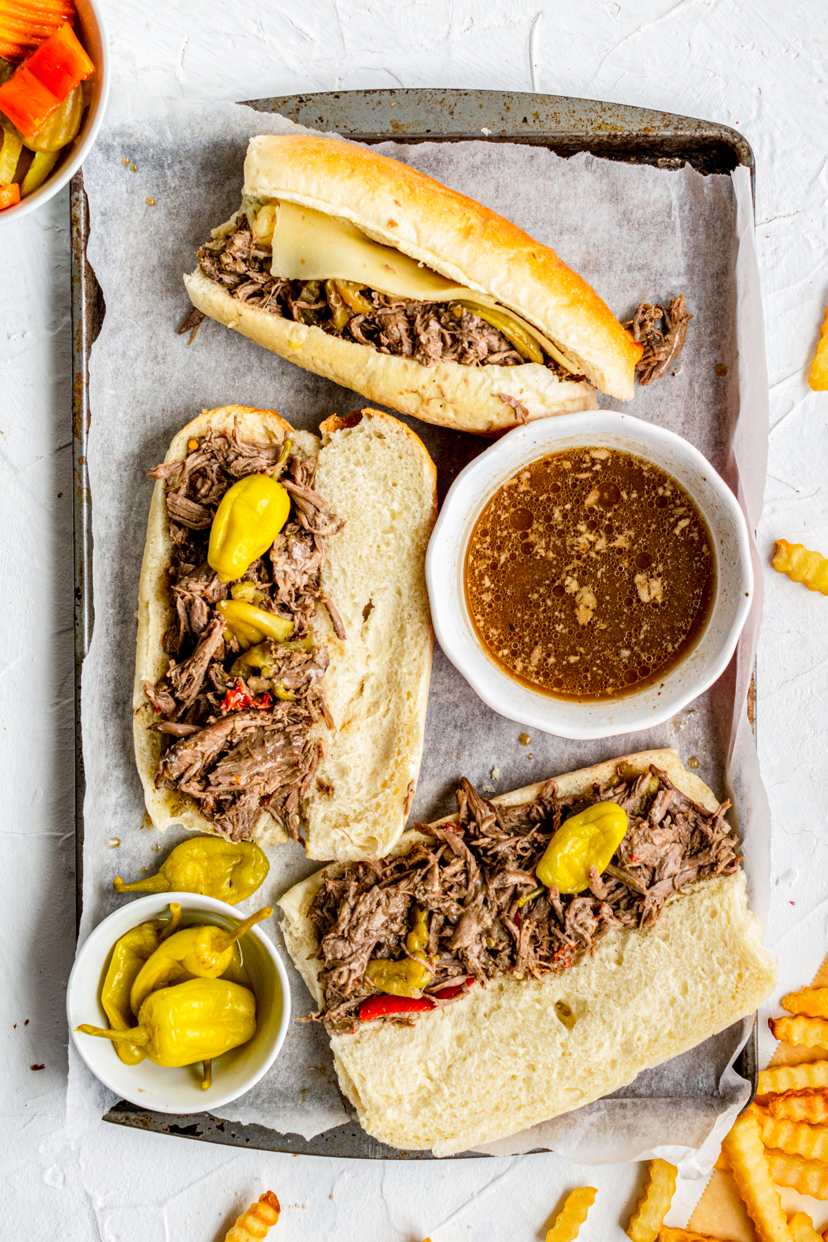 Overhead of Italian Beef Sandwiches open with dip on tray