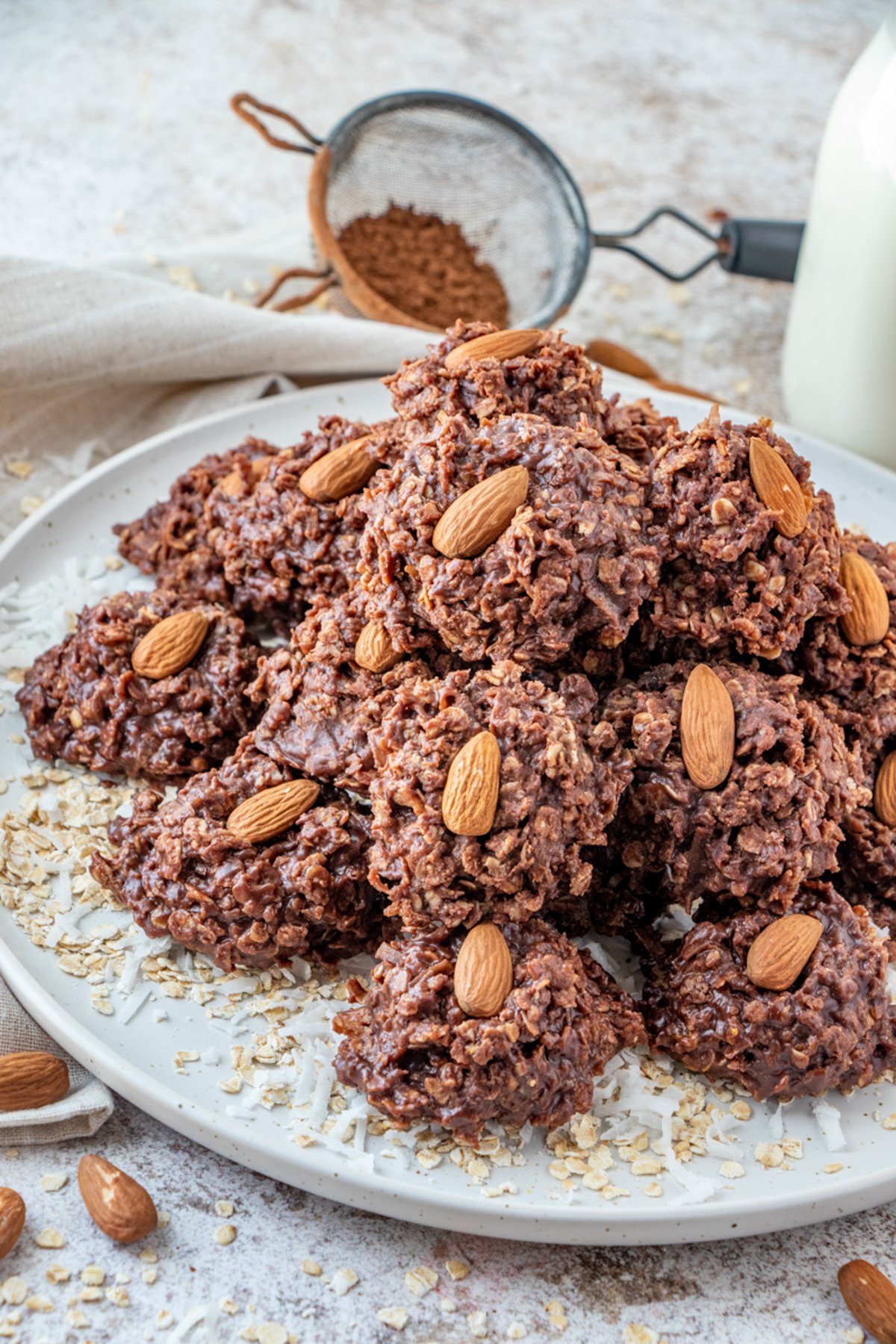 Plate full of No Bake Almond Joy Cookies topped with almonds