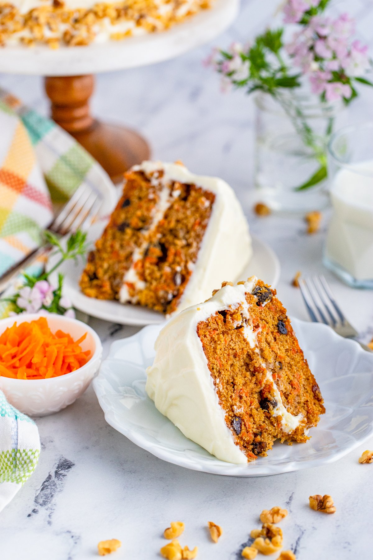 Two slices of Carrot Cake on white plates