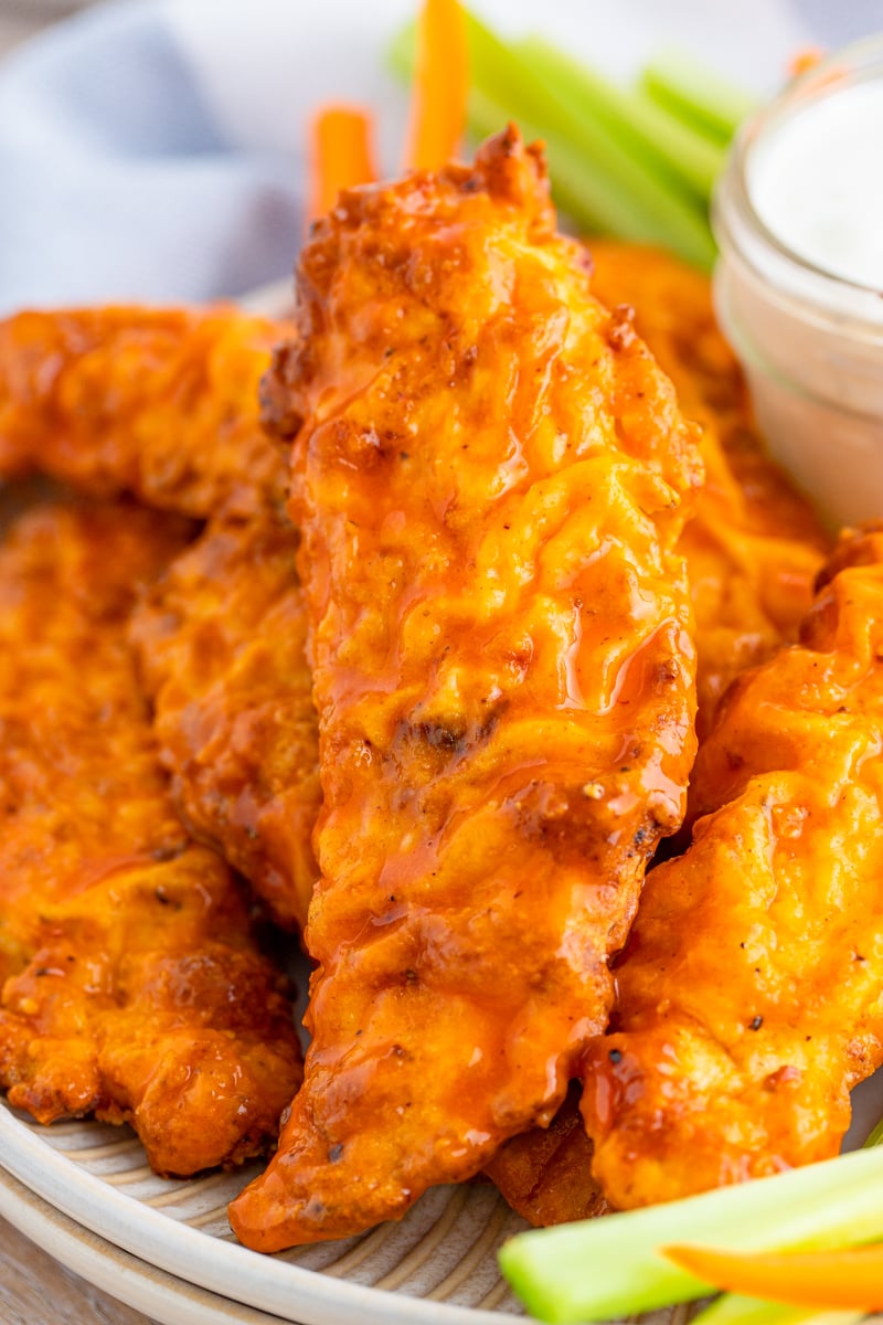 Close up of one Buffalo Chicken Tender on plate