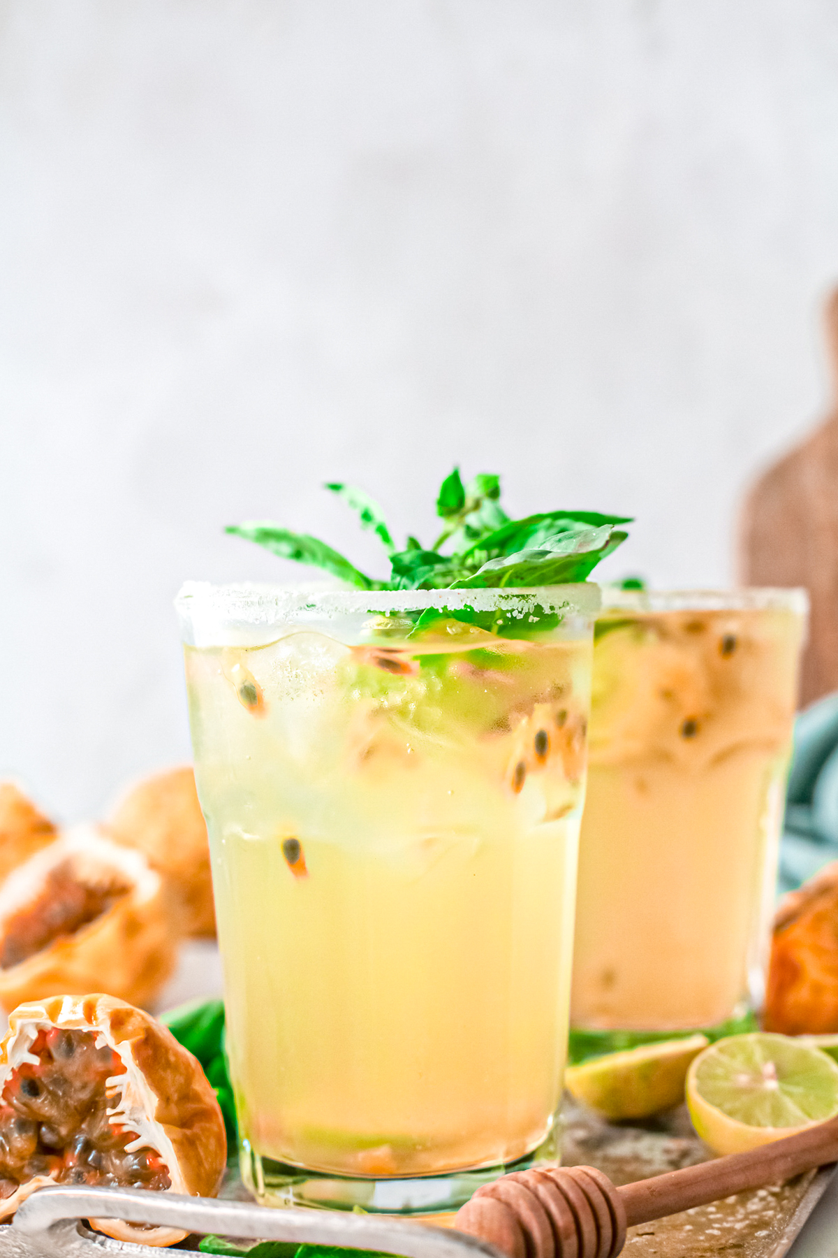 Close up glasses of Passion Fruit Margaritas with fresh herbs