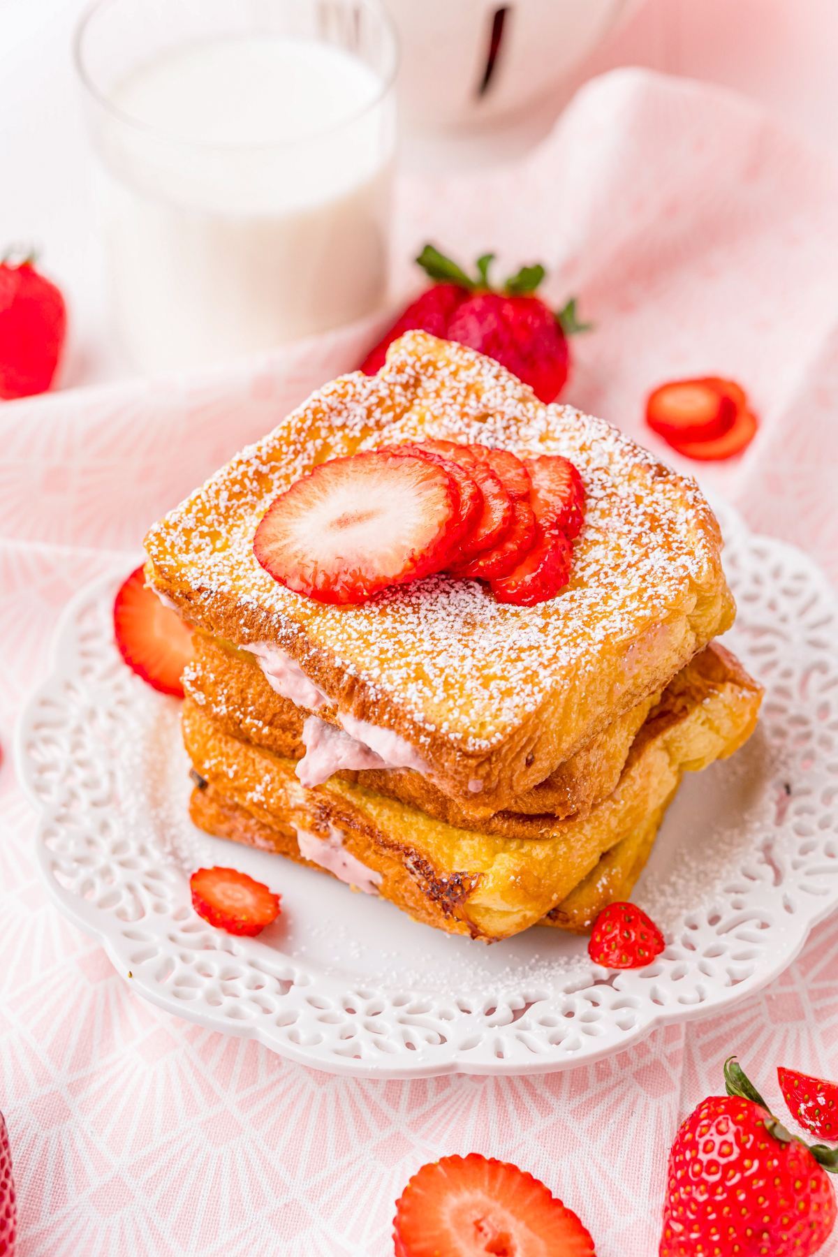 Strawberry Cheesecake Stuffed French Toast on white plate stacked