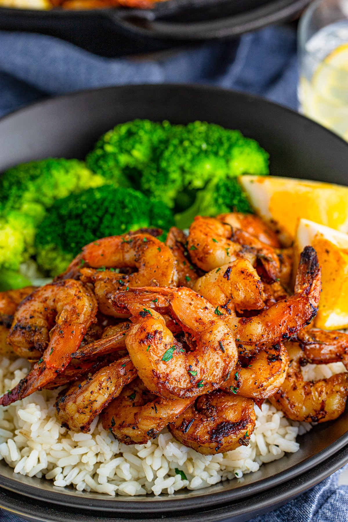 Blackened Shrimp over rice on plate with broccoli and lemon