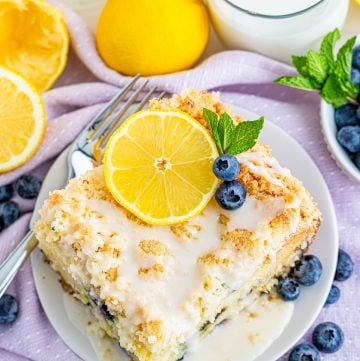 Overhead photo of slice of Lemon Blueberry Cake on white plate