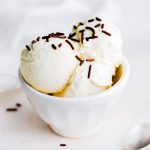 Square image of No Churn Ice Cream in white bowl with chocolate sprinkles