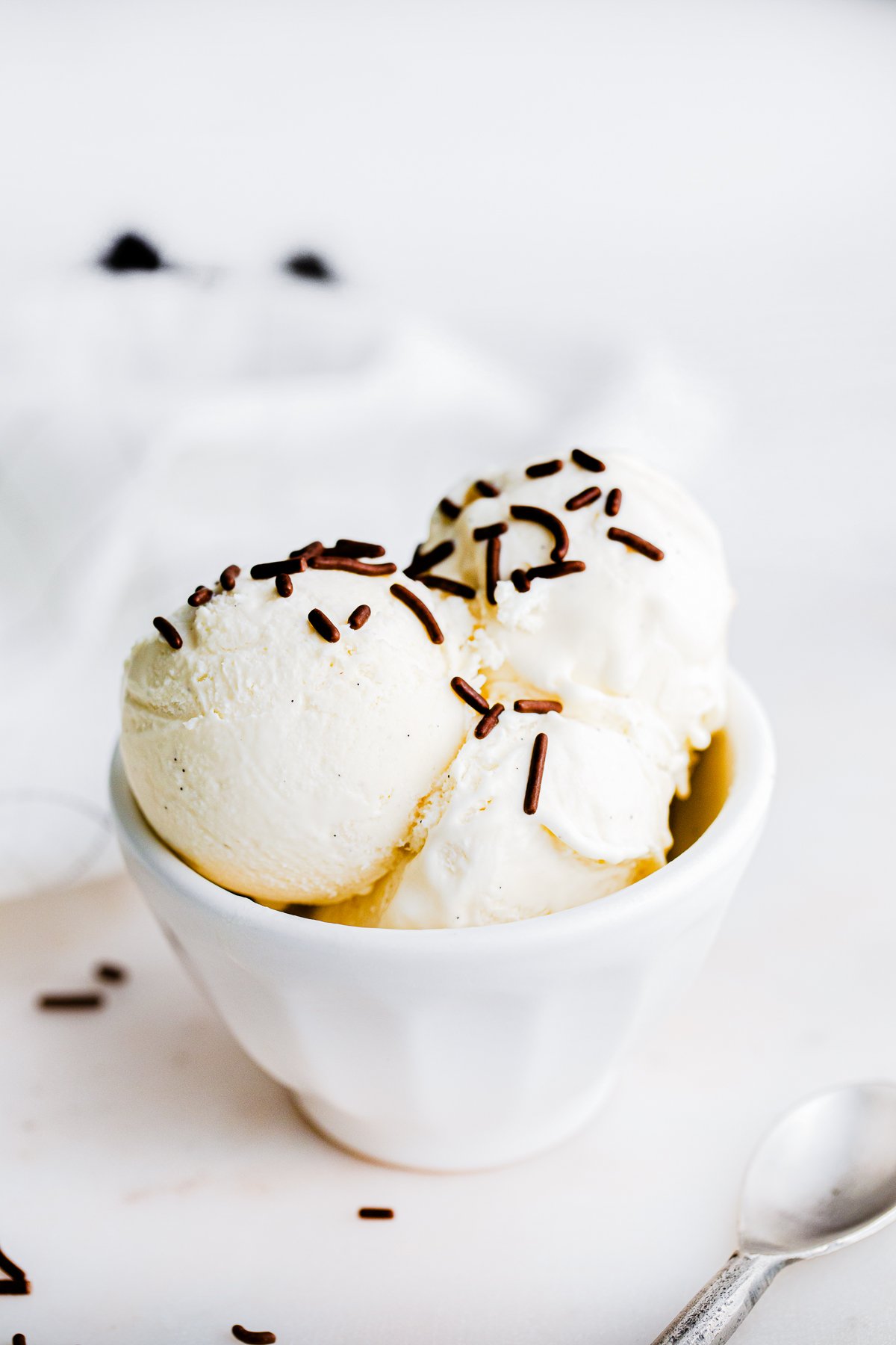 Ice cream in white bowl with chocolate sprinkles