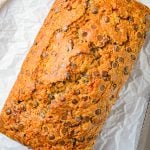 Finished loaf of bread out of pan on parchment paper