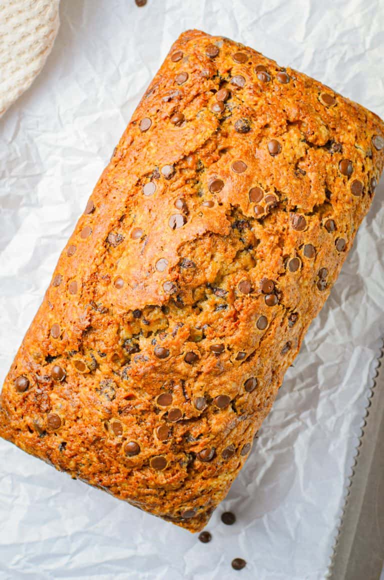 Finished loaf of bread out of pan on parchment paper
