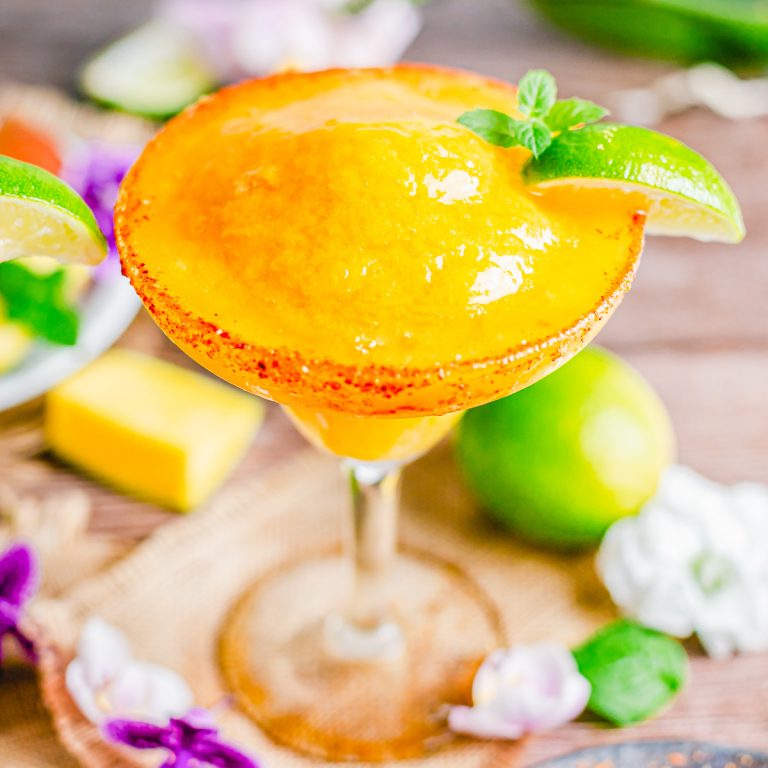 Square up close image of Margarita in glass with lime slice