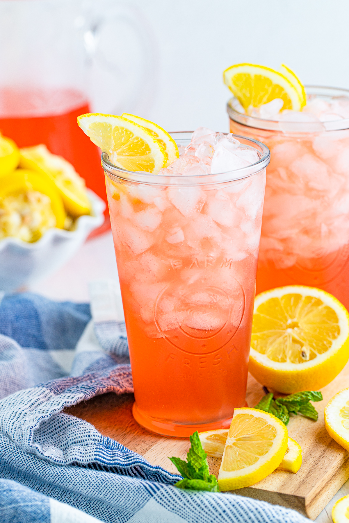 Two glasses of Pink Lemonade Recipe with lemons and mint