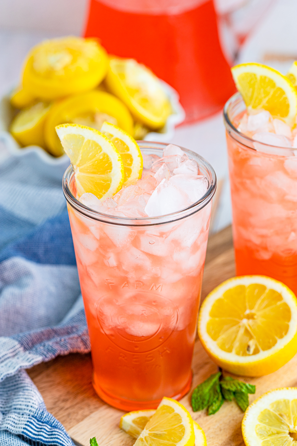 Glass of my Pink Lemonade Recipe with ice and lemon garnish