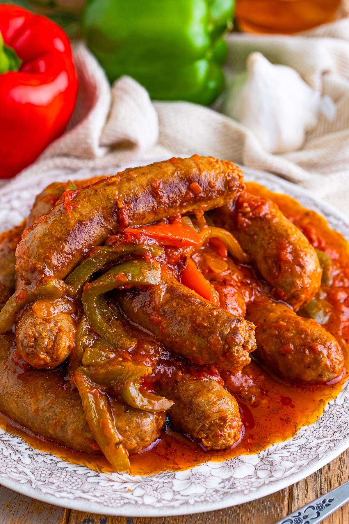 finished Italian Sausage and Peppers served on a tan plate