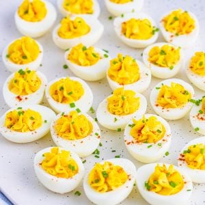 Squarer image of Deviled Eggs on white platter.