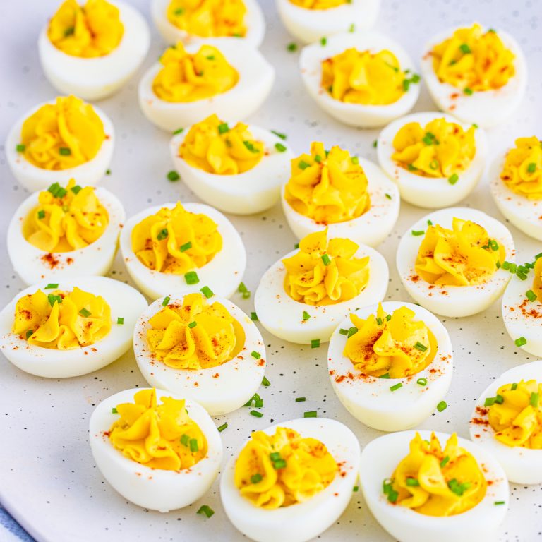 Squarer image of Deviled Eggs on white platter.