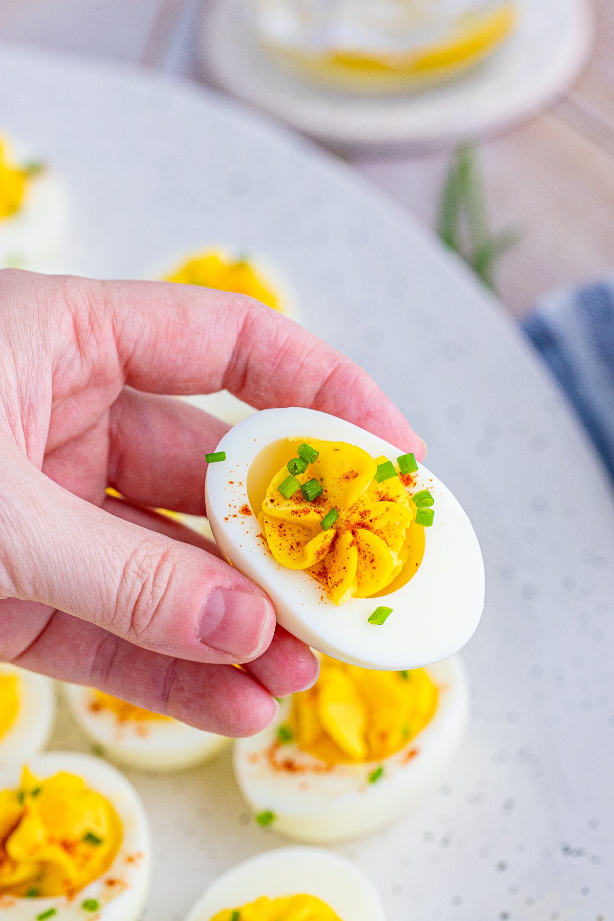 Hand holding on Easy Deviled Egg Recipe