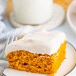 Cut Pumpkin Bar Recipe slice on white plate frosted.