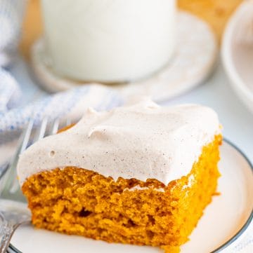 Cut Pumpkin Bar Recipe slice on white plate frosted.
