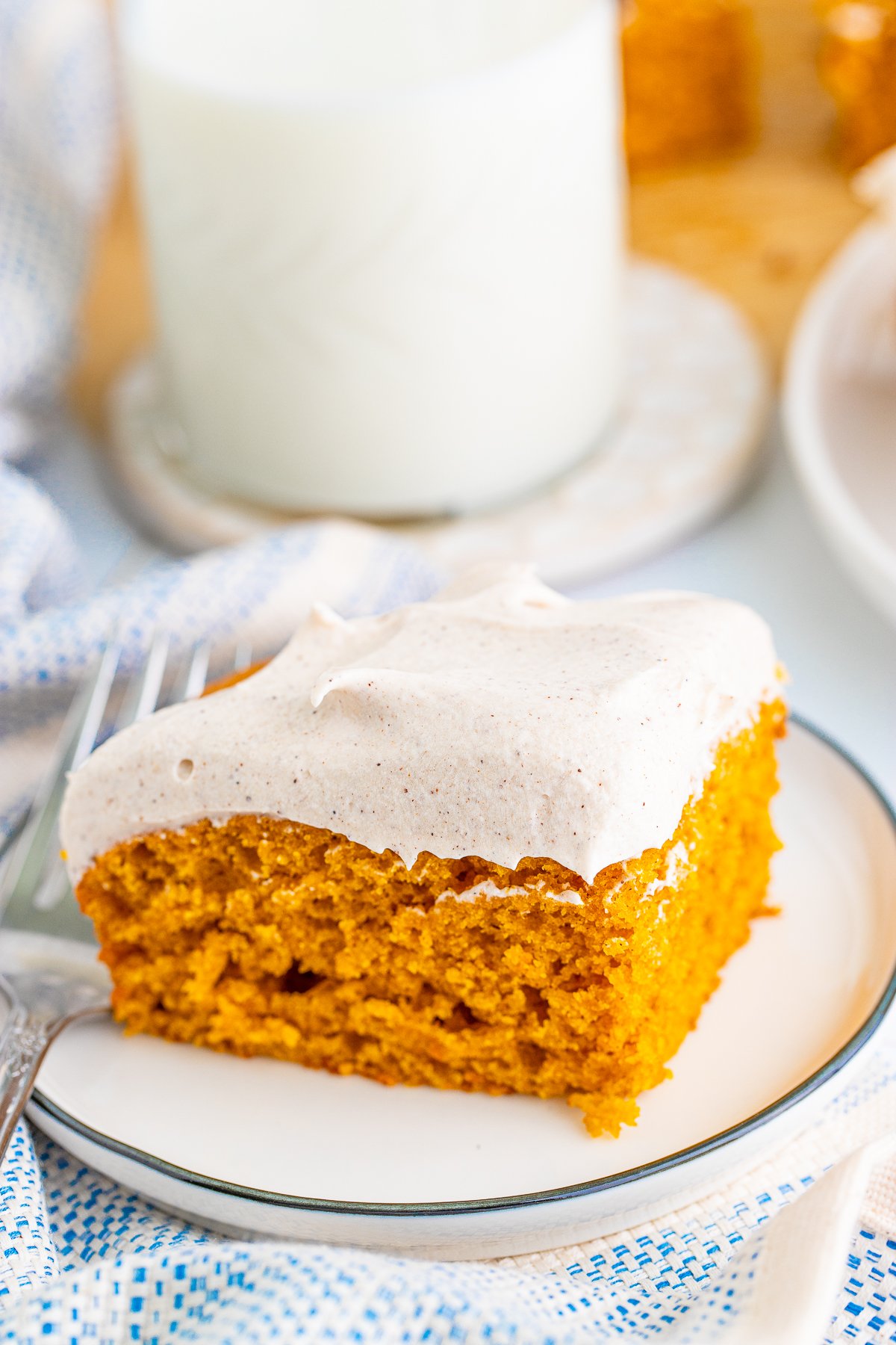 Cut Pumpkin Bar Recipe slice on white plate frosted.