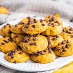 Stacked Pumpkin Chocolate Chip Cookie Recipe on white plate.