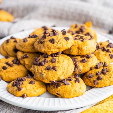 Stacked Pumpkin Chocolate Chip Cookie Recipe on white plate.