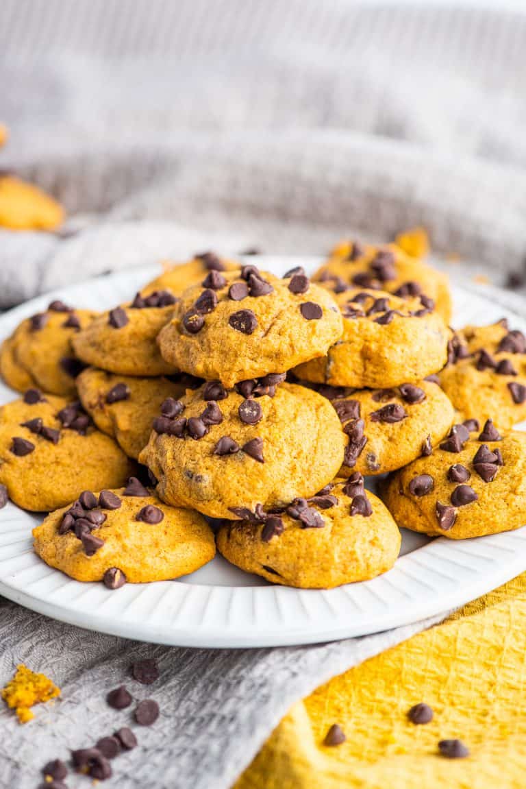 Stacked Pumpkin Chocolate Chip Cookie Recipe on white plate.