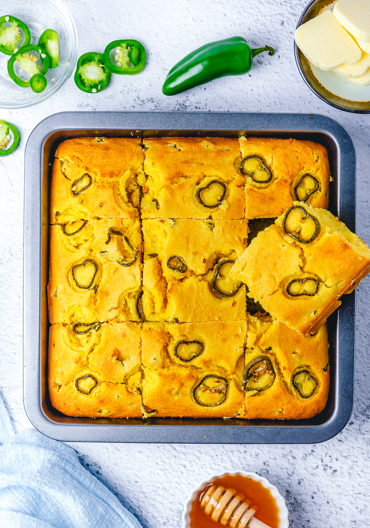 Finished Jalapeno Cornbread in baking pan with slice cut out and stacked on top.