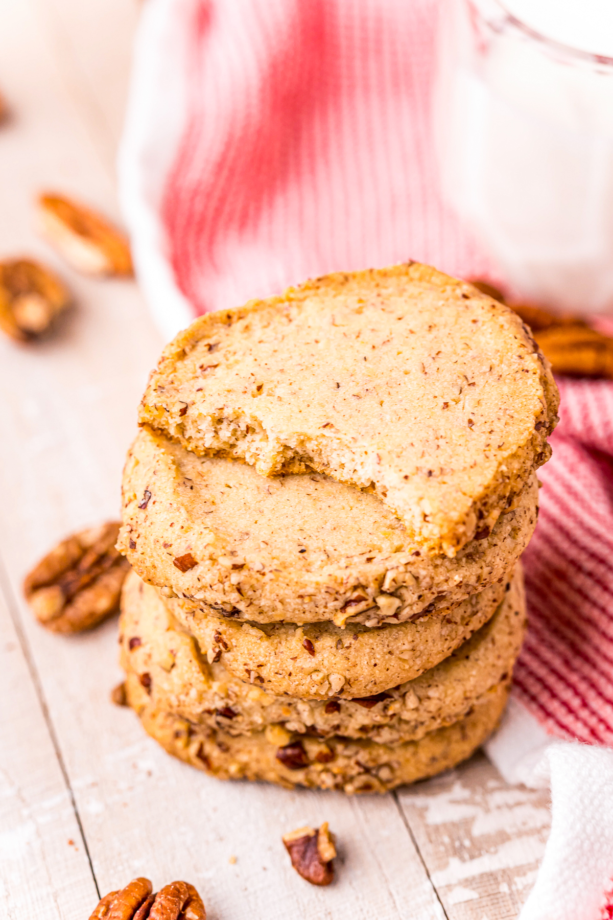 Stacked Pecan Sandies with bite taken out of top cookie.