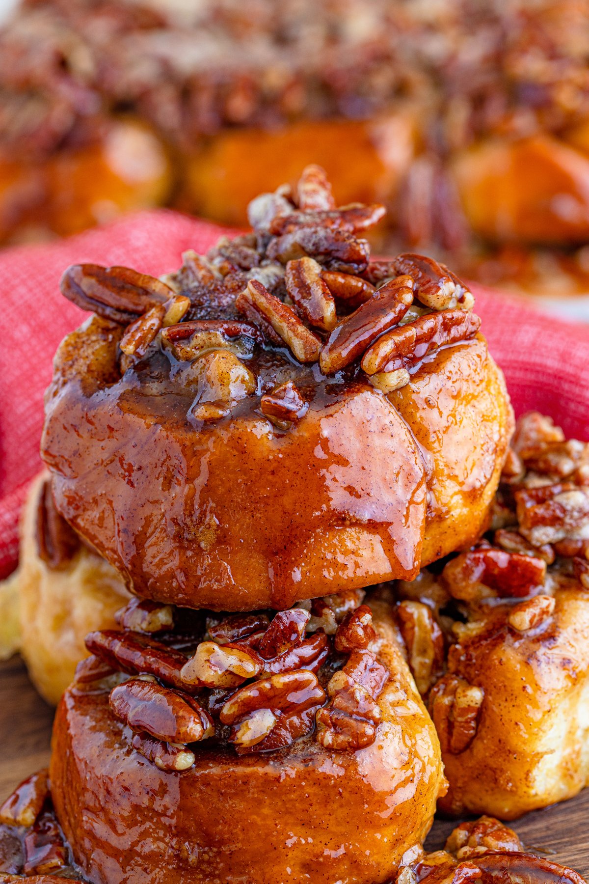 Stacked Pecan Sticky Buns on plate.