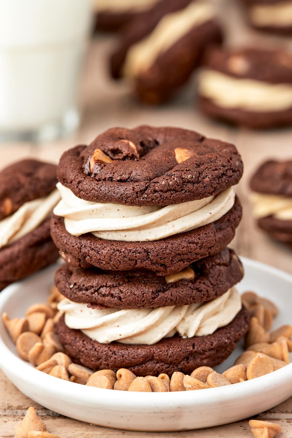 Two stacked Reese's Sandwich Cookies on plate with peanuts.
