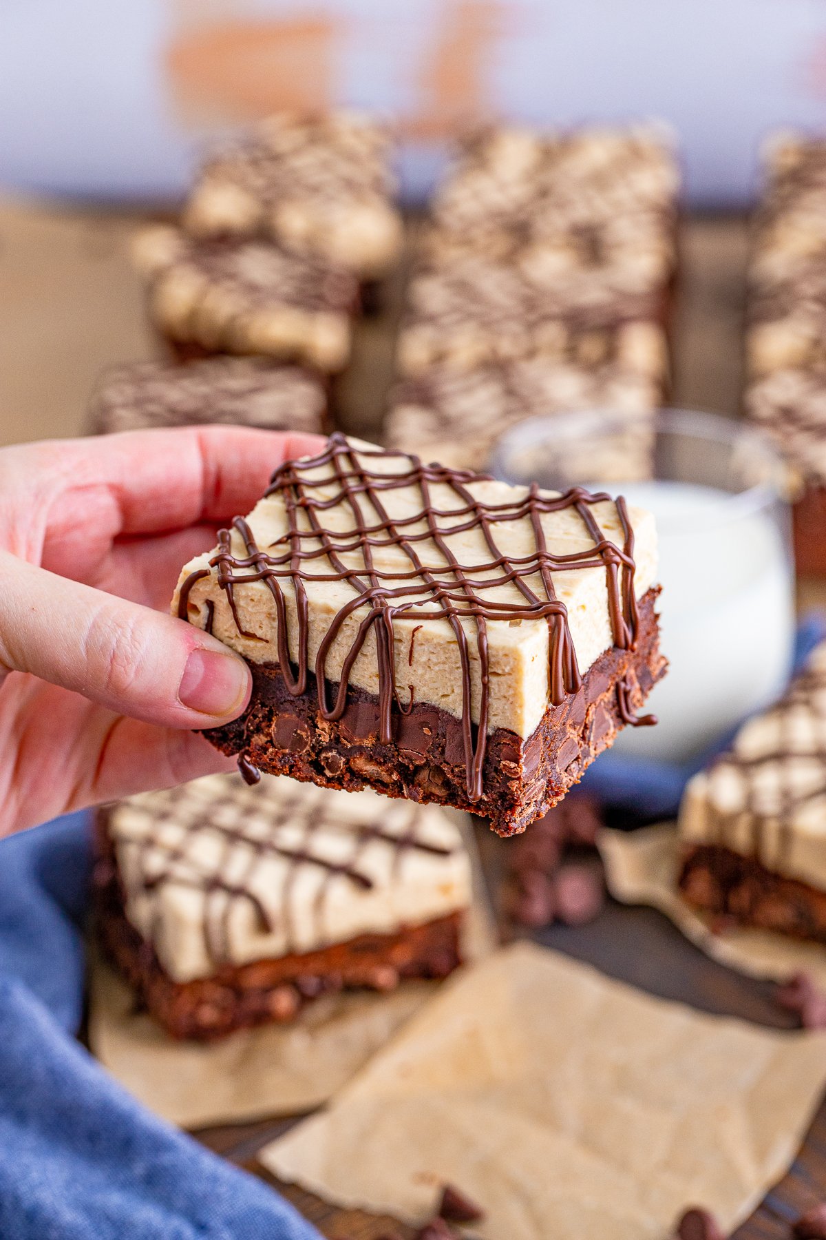 Hand holding up one Peanut Butter Brownie.